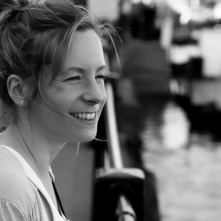 Avery Lee, Lead Design Curator at CryptoVerdaLine, reviewing corporate floral arrangements